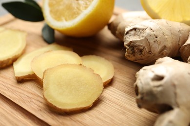 Fresh lemon and ginger on wooden board, closeup