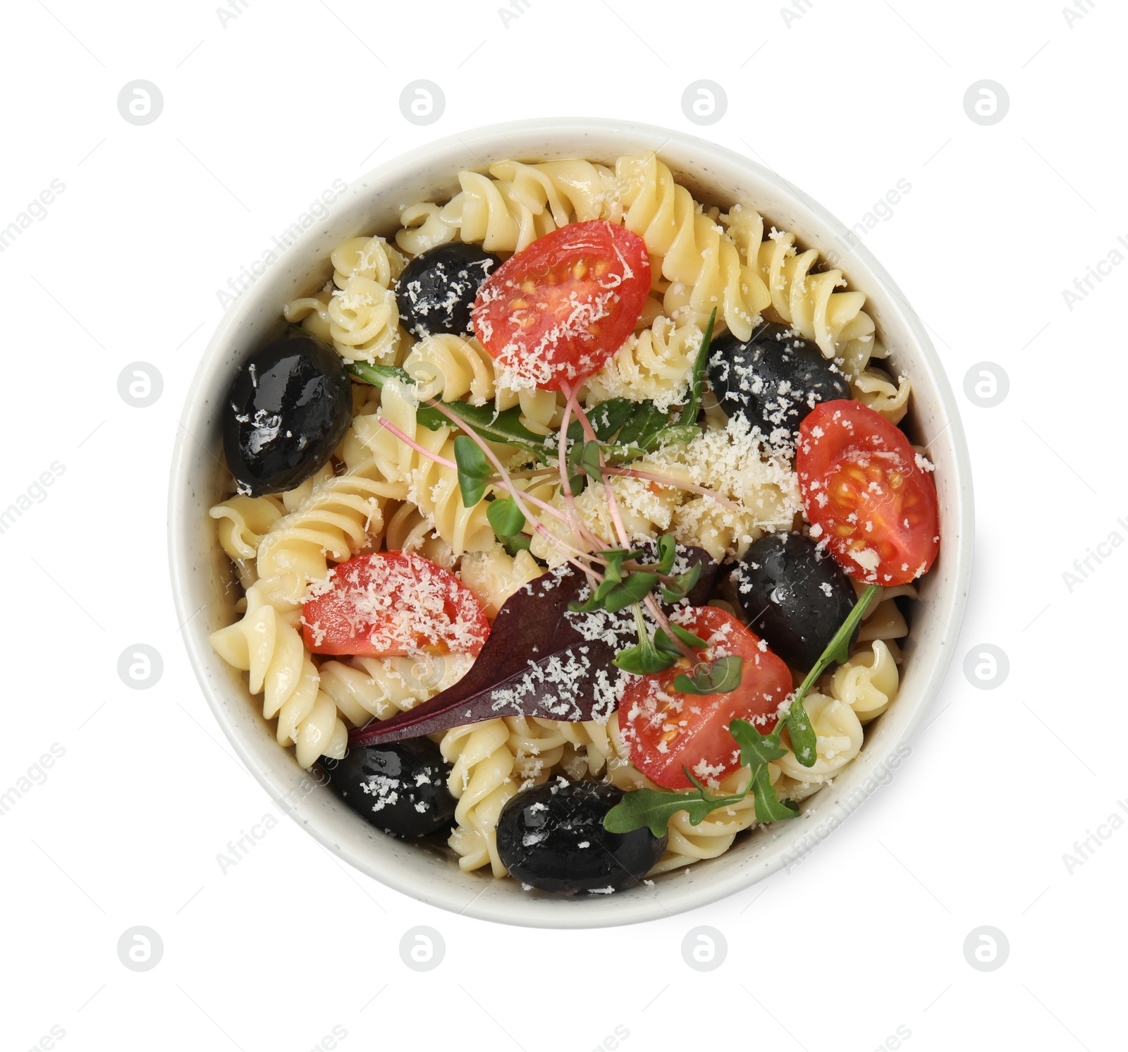 Photo of Bowl of delicious pasta with tomatoes, olives and cheese on white background, top view