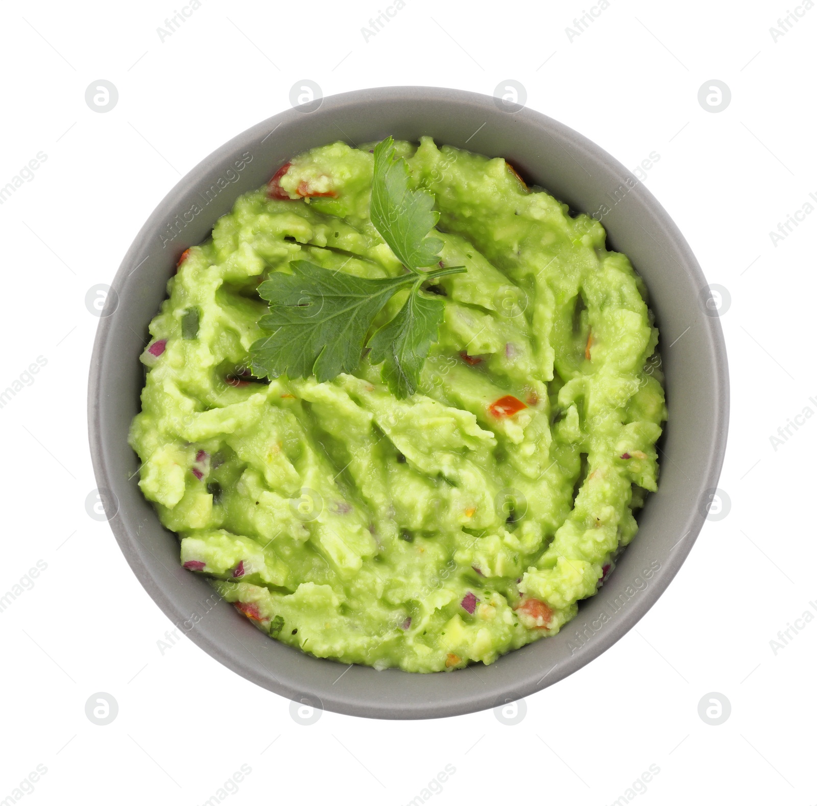 Photo of Bowl of delicious guacamole with parsley isolated on white, top view