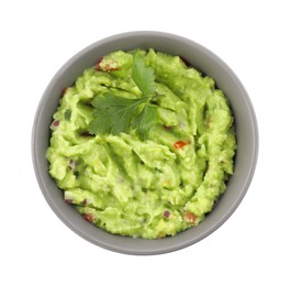 Bowl of delicious guacamole with parsley isolated on white, top view