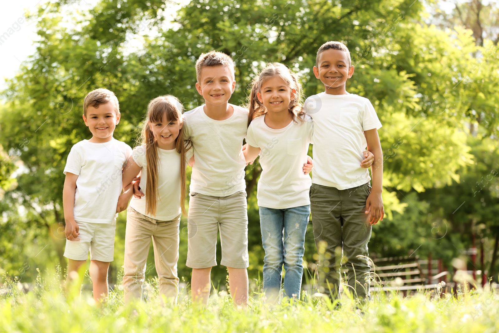 Photo of Group of children huddling in park. Volunteer project