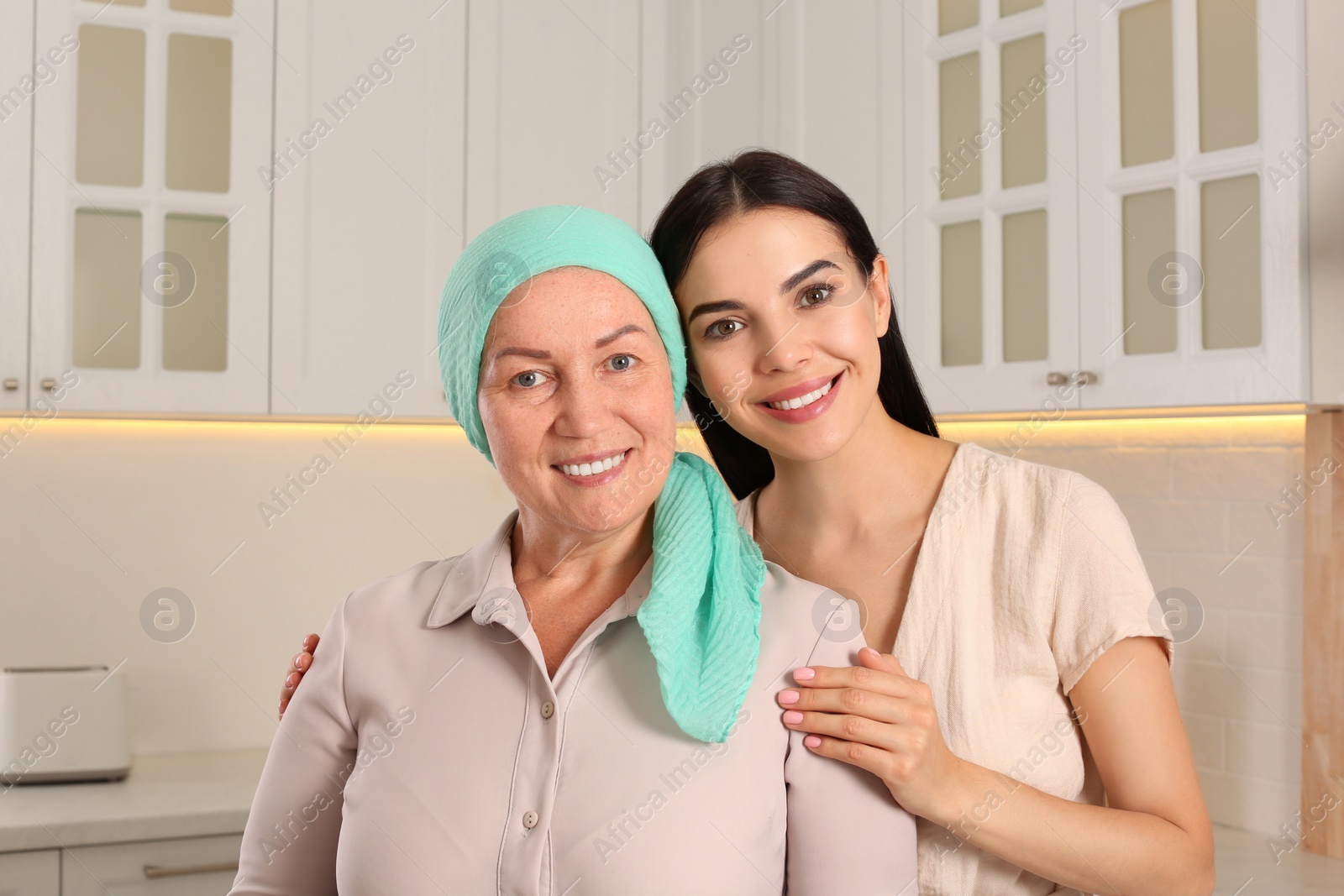 Photo of Young woman visiting her mother with cancer indoors