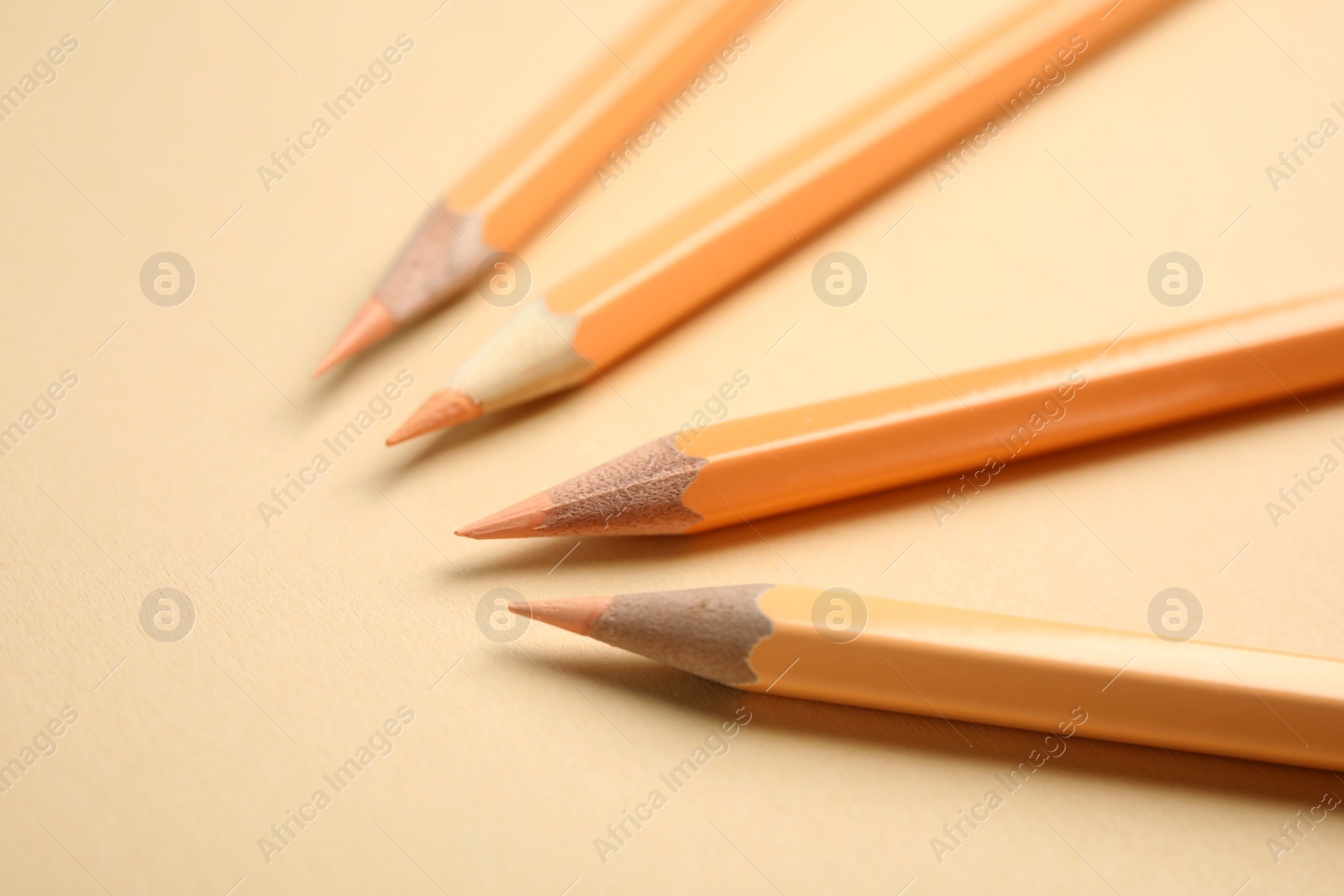 Photo of Composition with color pencils on beige background