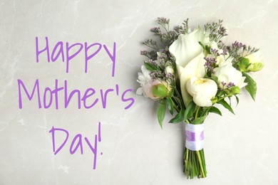 Happy Mother's Day. Bouquet of beautiful flowers on light table, top view