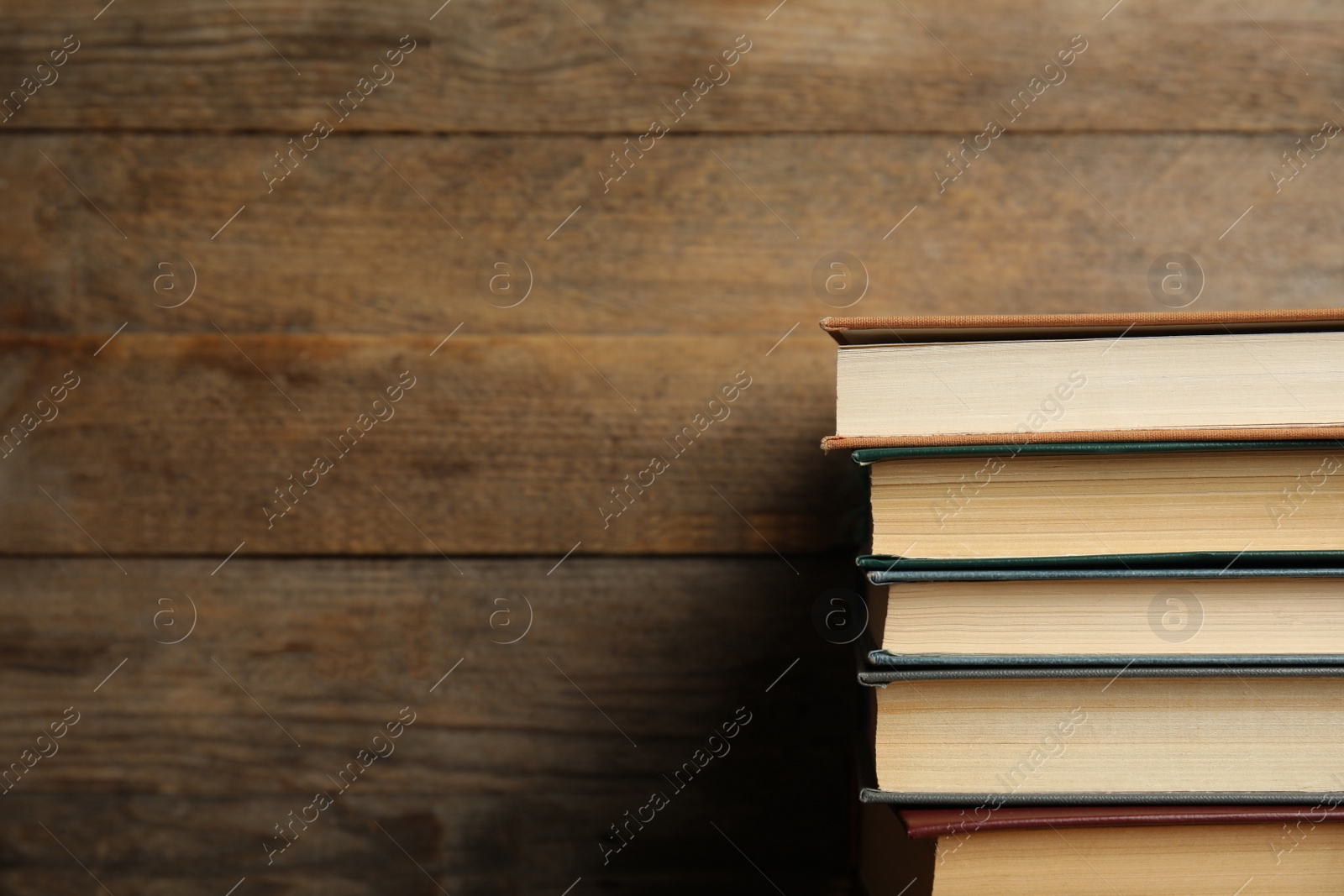 Photo of Collection of different books on wooden background. Space for text