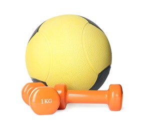 Medicine ball and dumbbells on white background