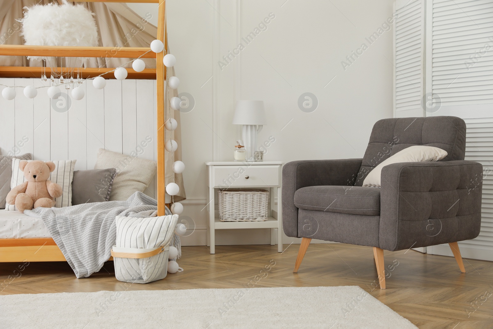 Photo of Stylish room for kid with house bed. Interior design