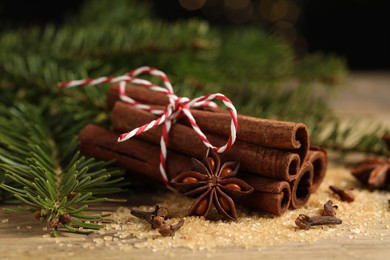 Photo of Different spices and fir branches on table, closeup