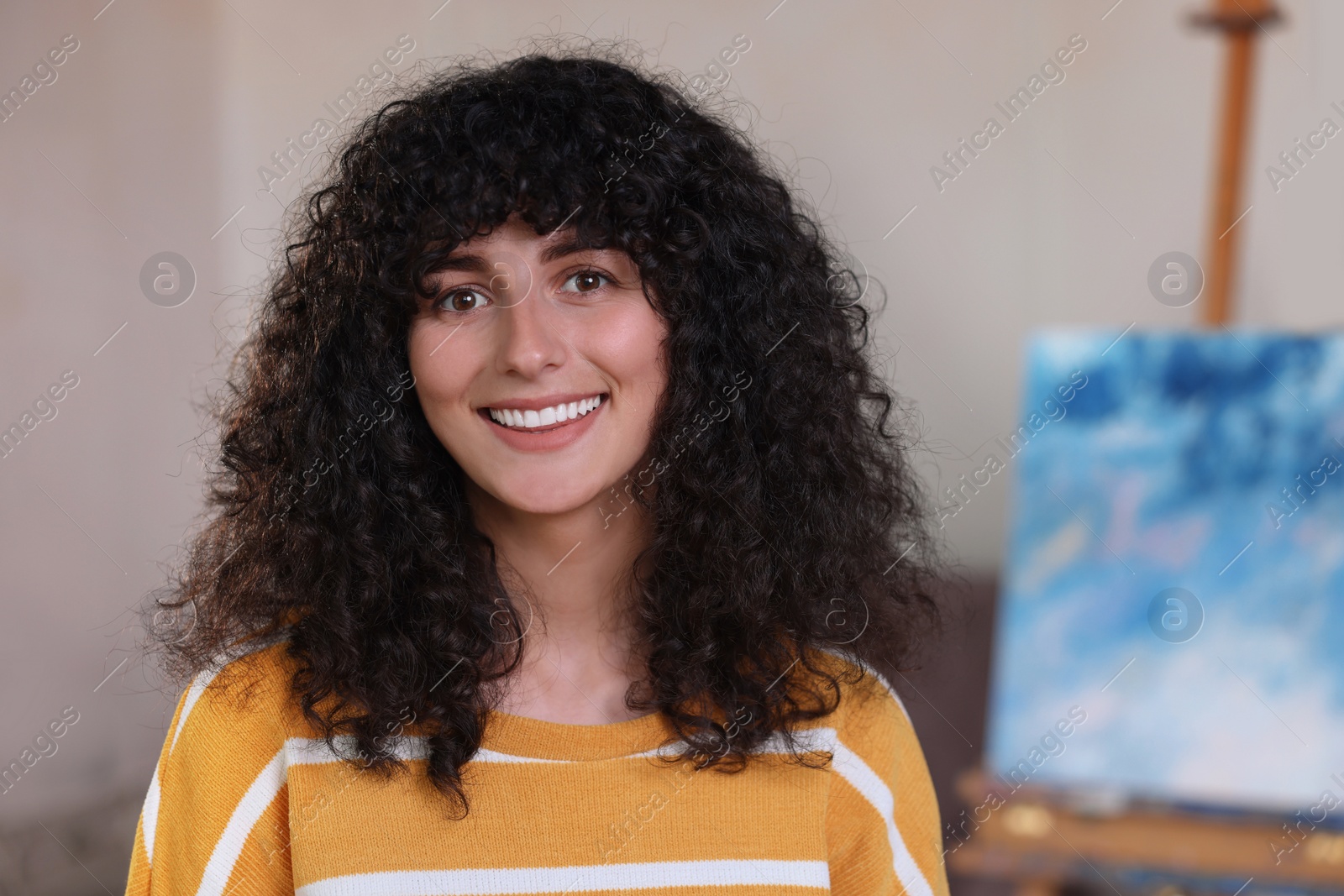 Photo of Portrait of happy young woman in stylish sweater indoors