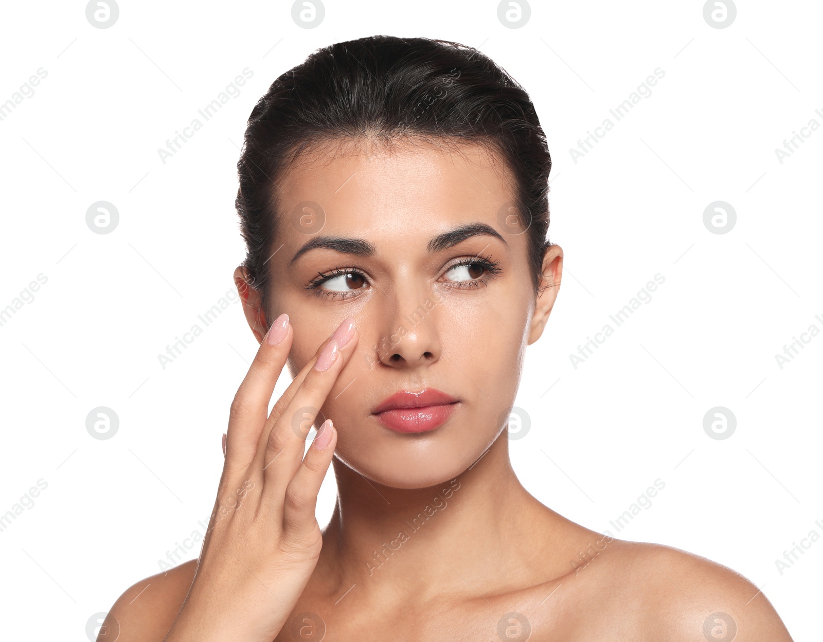 Photo of Woman applying cream under eyes on white background. Skin care