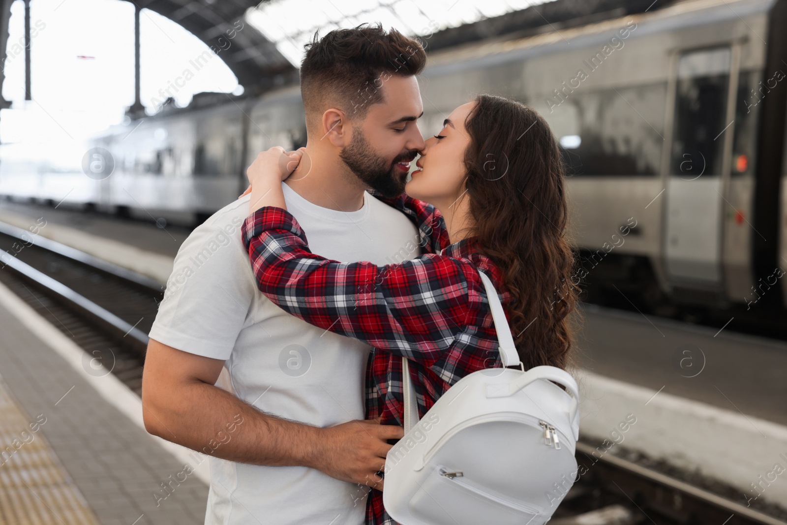 Photo of Long-distance relationship. Beautiful couple on platform of railway station