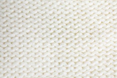 White knitted sweater as background, closeup view