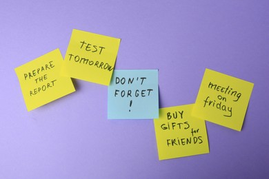 Photo of Many different reminder notes on violet background