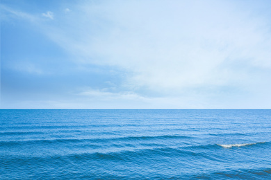 Beautiful wavy sea under blue sky with clouds