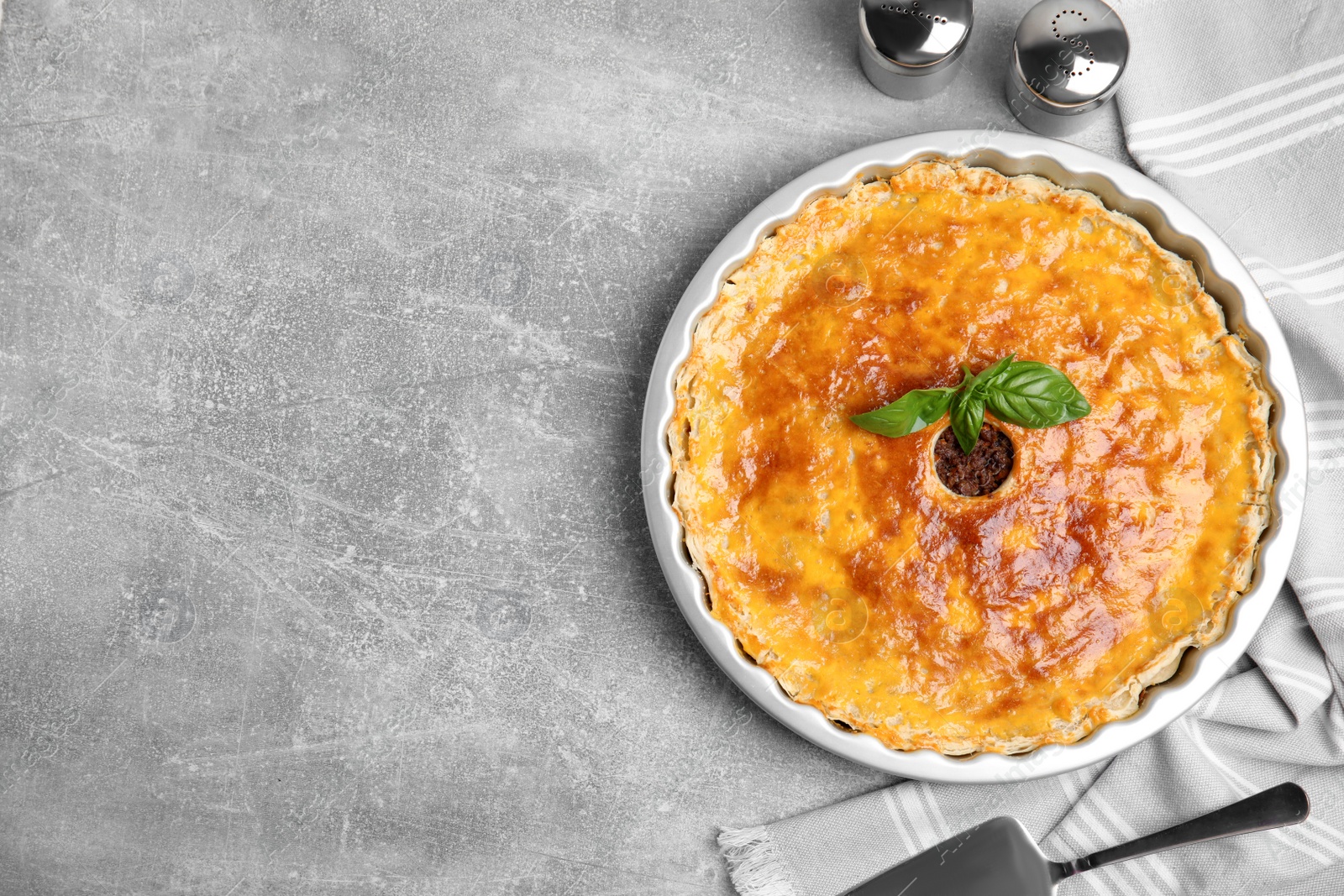 Photo of Delicious pie with minced meat on light grey table, flat lay. Space for text