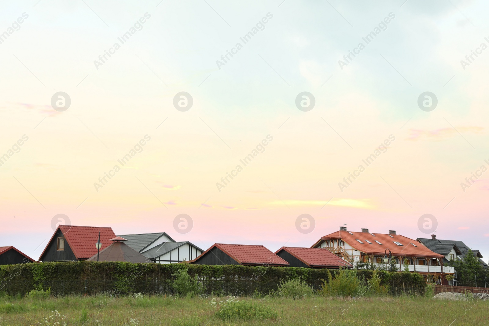 Photo of Modern buildings with different roofs outdoors on spring day