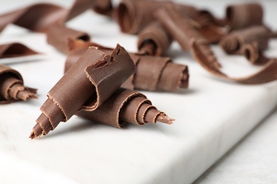 Photo of Chocolate curls for decor on board, closeup