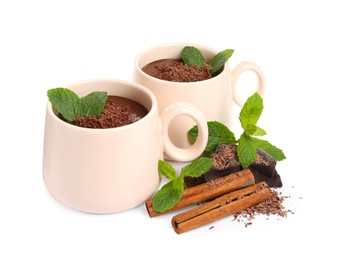 Photo of Cups of delicious hot chocolate with mint and cinnamon sticks on white background