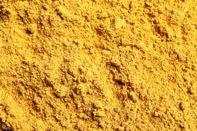 Photo of Dry curry powder as background, top view