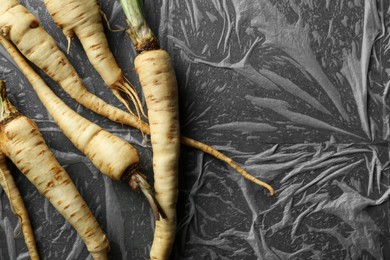 Delicious fresh ripe parsnips on grey table, flat lay. Space for text