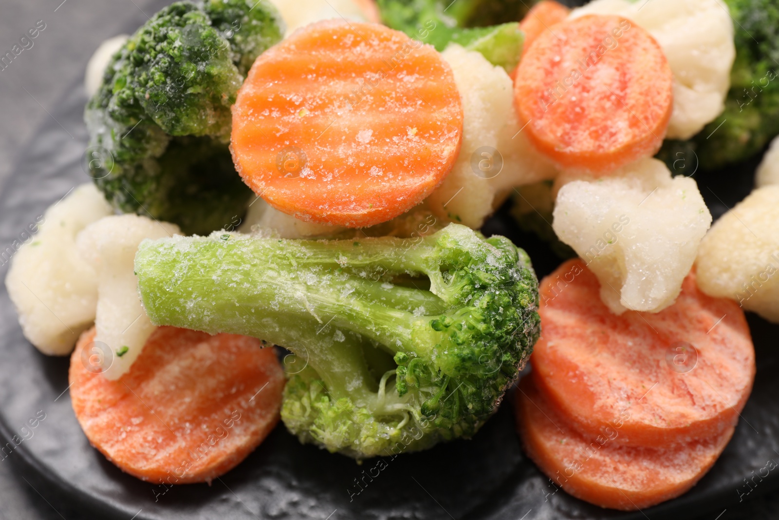 Photo of Mix of different frozen vegetables on table, closeup