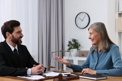 Photo of Senior woman having meeting with lawyer in office