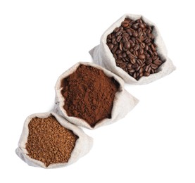 Bags with different types of coffee on white background, top view
