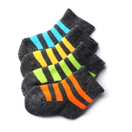 Photo of Cute child socks on white background, top view