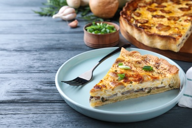 Photo of Delicious pie with mushrooms and cheese served on grey wooden table