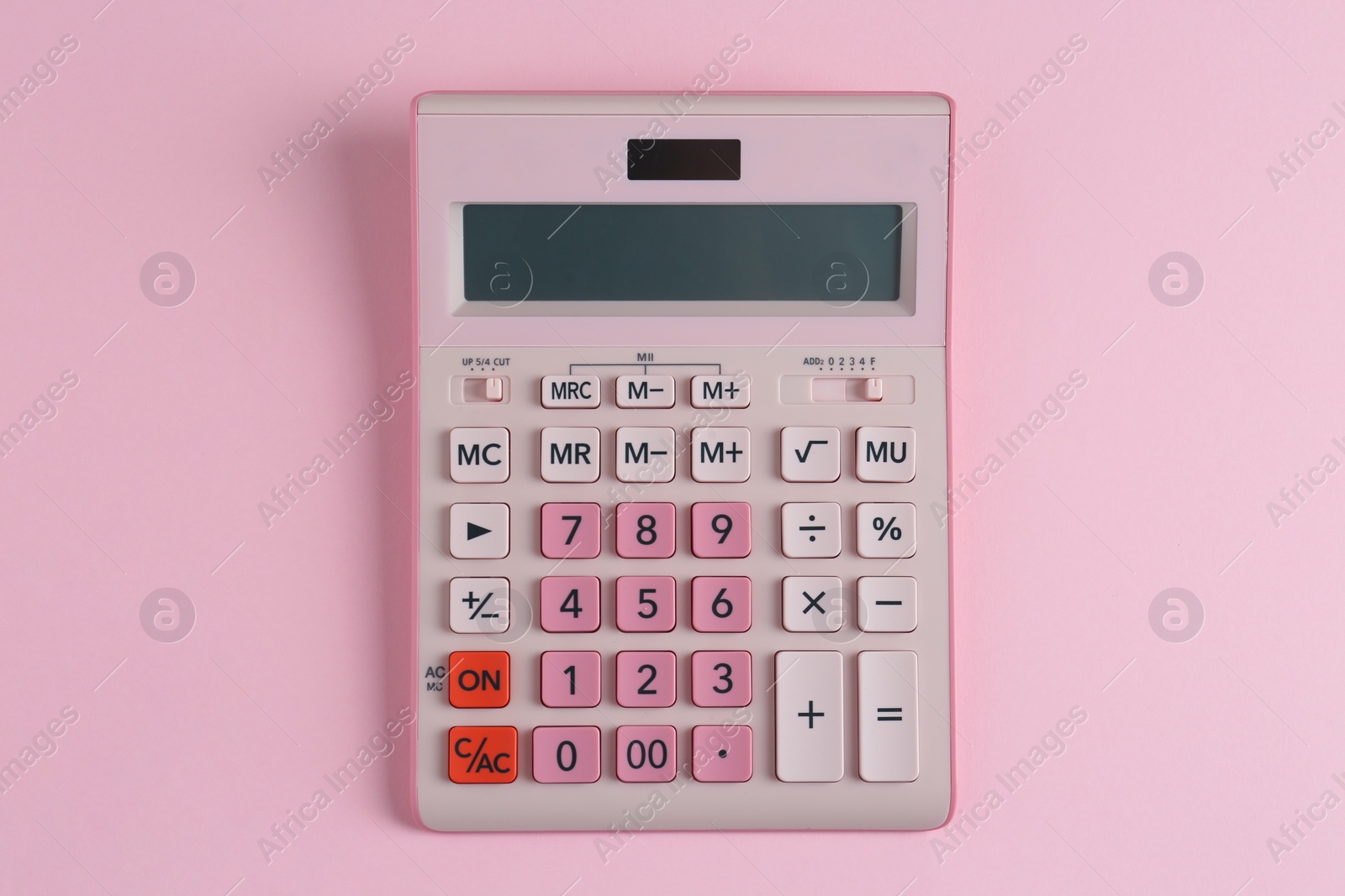 Photo of Modern calculator on pink background, top view