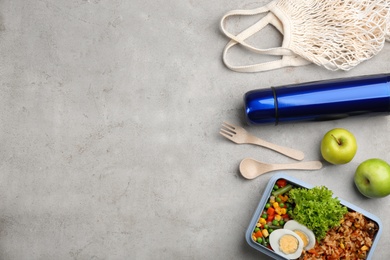 Photo of Flat lay composition with thermos and food on light grey table. Space for text