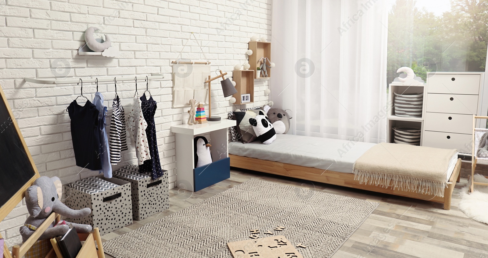 Photo of Montessori bedroom interior with floor bed and toys