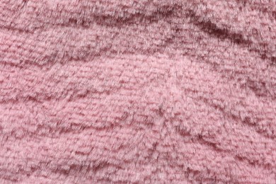 Texture of pink faux fur as background, top view