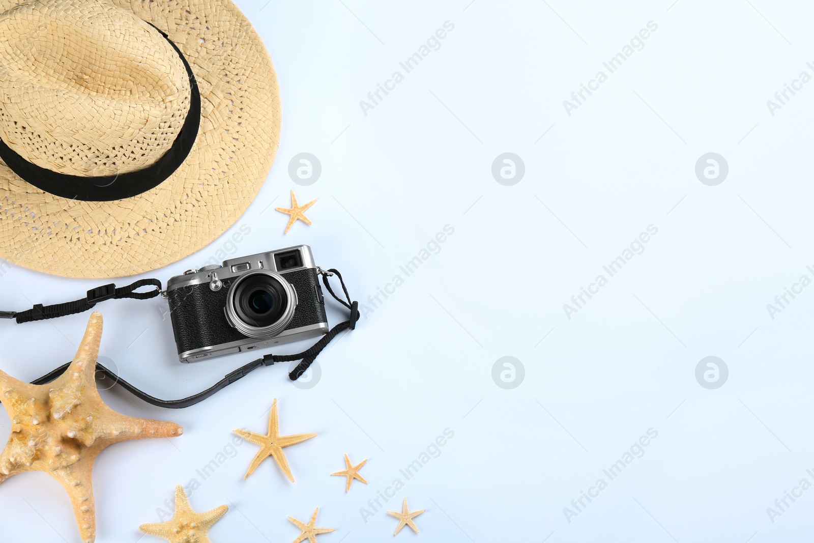 Photo of Camera for professional photographer and beach objects on white background, top view