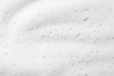 Photo of Fluffy soap foam as background, top view