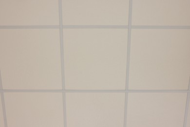 Photo of White ceiling with PVC tiles, view from below