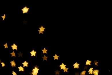Photo of Blurred view of star shaped lights on black background. Bokeh effect