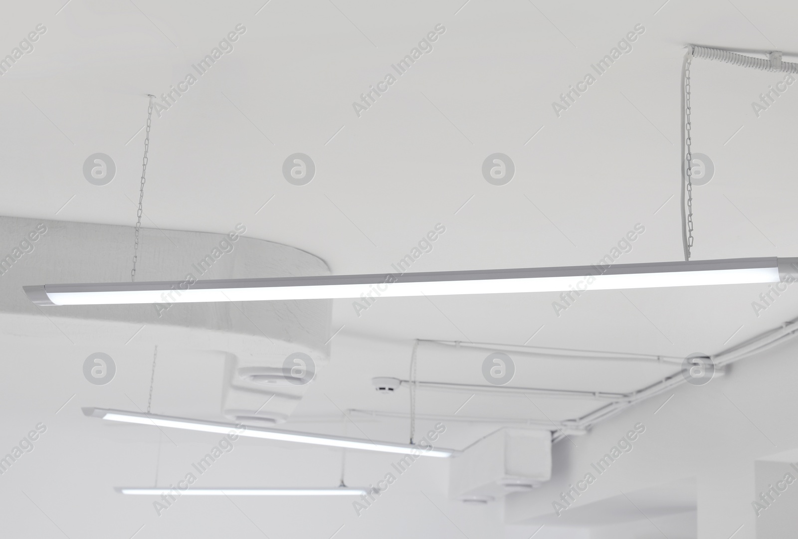 Photo of White ceiling with modern lighting in room