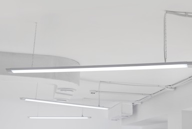 Photo of White ceiling with modern lighting in room