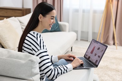Photo of Beautiful young woman with laptop shopping online at home