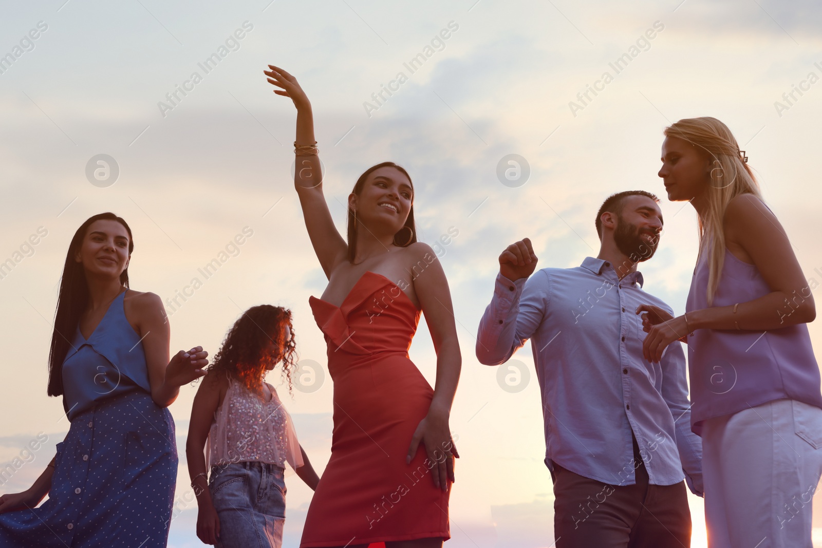 Photo of Group of friends having fun at summer party, low angle view