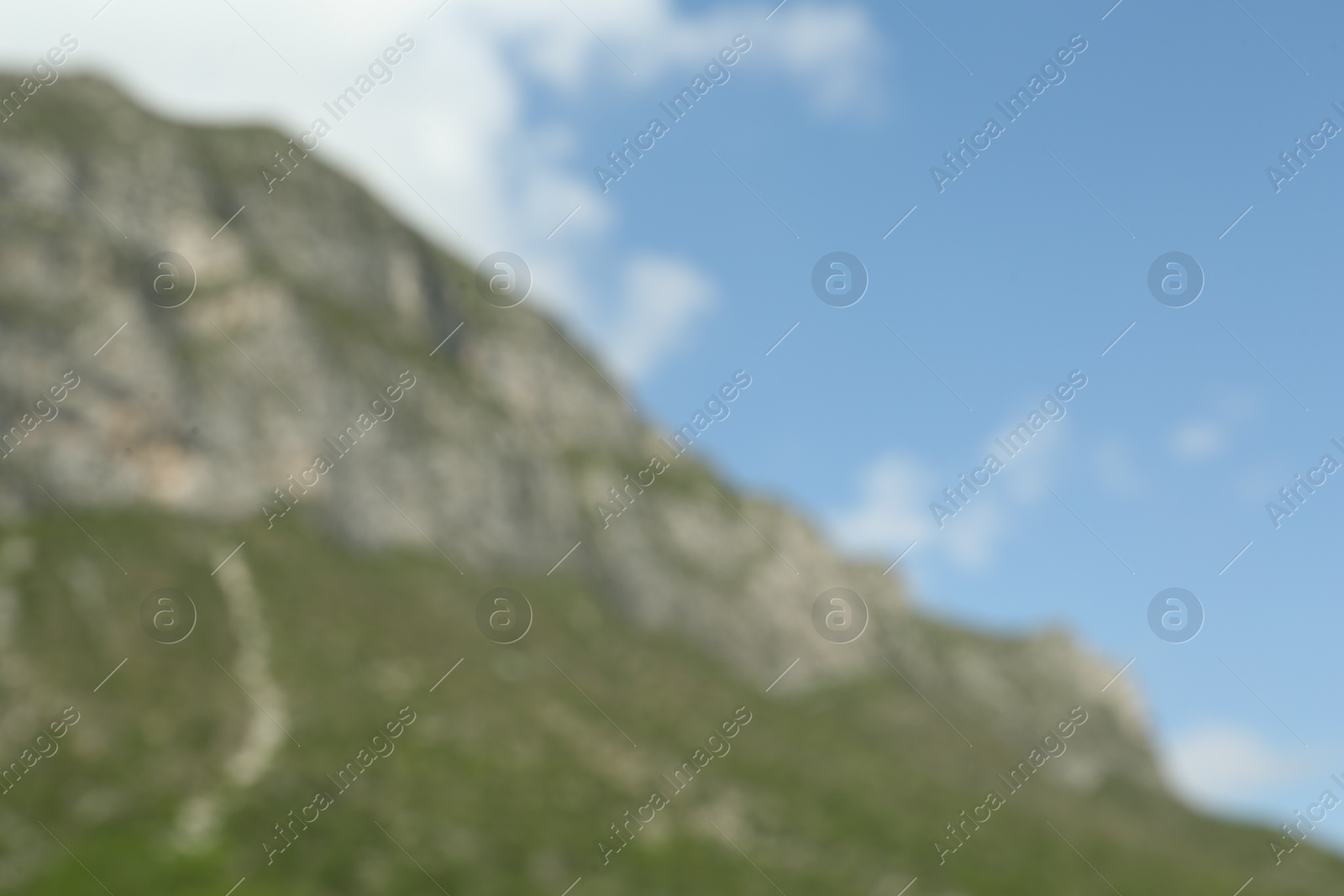 Photo of Beautiful mountain and plants under cloudy sky, blurred view