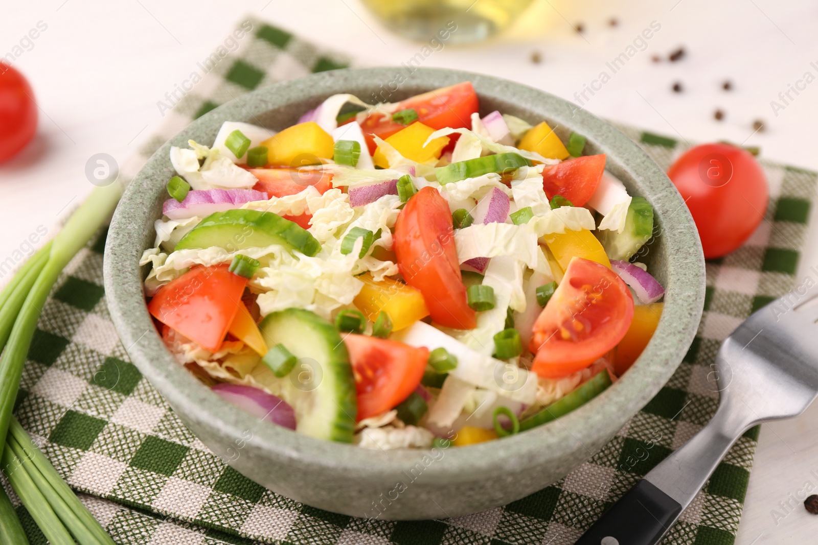 Photo of Tasty salad with Chinese cabbage in bowl on table, closeup