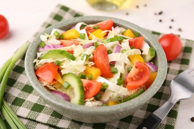 Photo of Tasty salad with Chinese cabbage in bowl on table, closeup