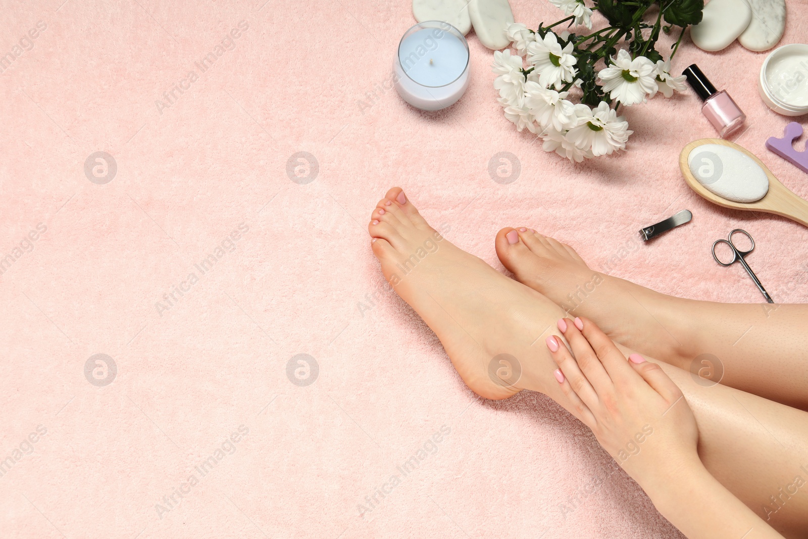 Photo of Woman with neat toenails after pedicure procedure on pink terry towel, closeup. Space for text