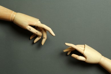 Photo of Wooden mannequin hands on grey background, flat lay