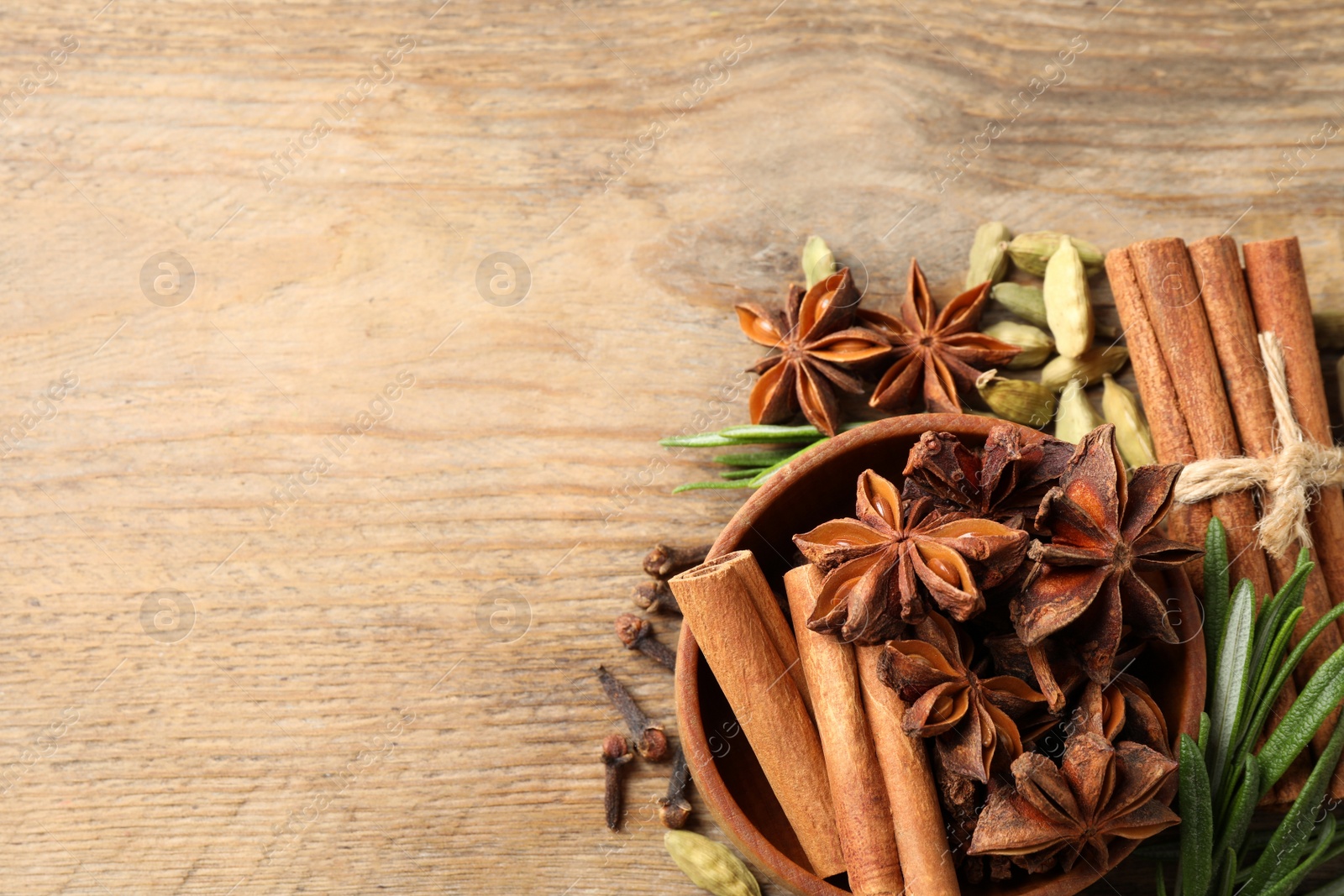 Photo of Flat lay composition with mulled wine ingredients on wooden table. Space for text