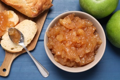 Photo of Flat lay composition with delicious apple jam on blue wooden table