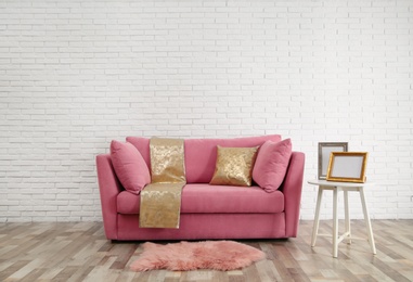 Photo of Modern living room interior with stylish pink sofa. Space for text