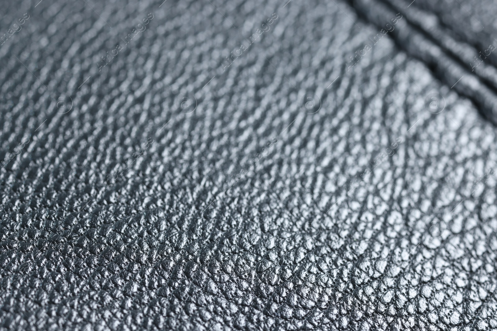 Photo of Black leather with seam as background, closeup